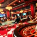 Players engaging at casino tables filled with excitement at 52bet, featuring poker chips and roulette wheels.